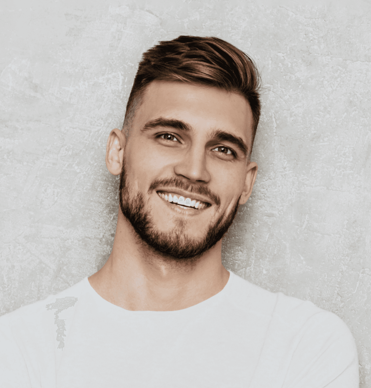 Illustrative photograph of a man smiling against a grey background